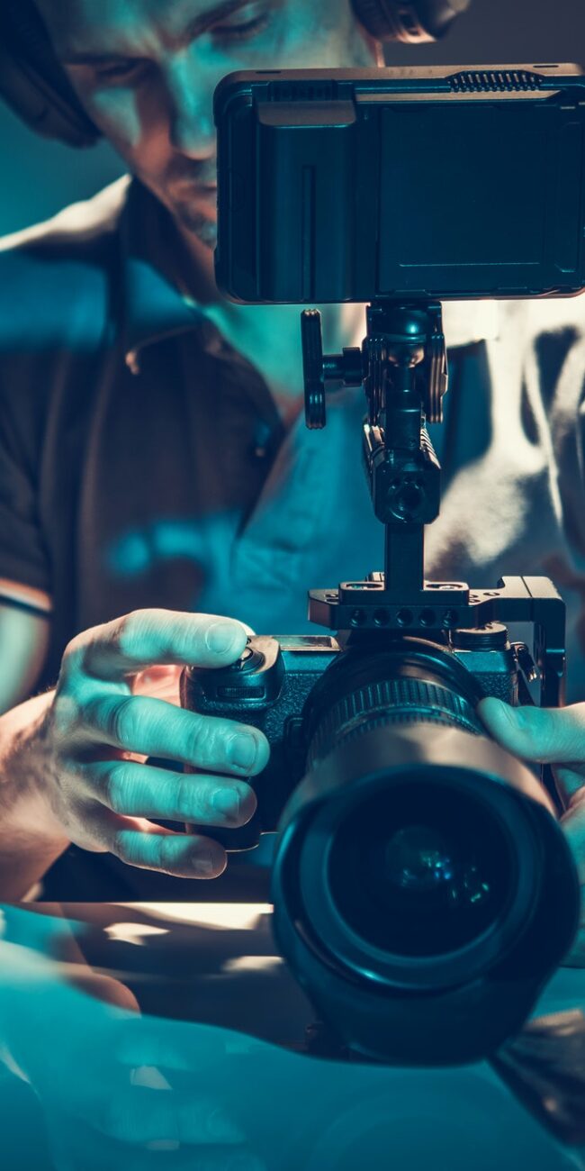 Camera Operator Reviewing Video Material on Display