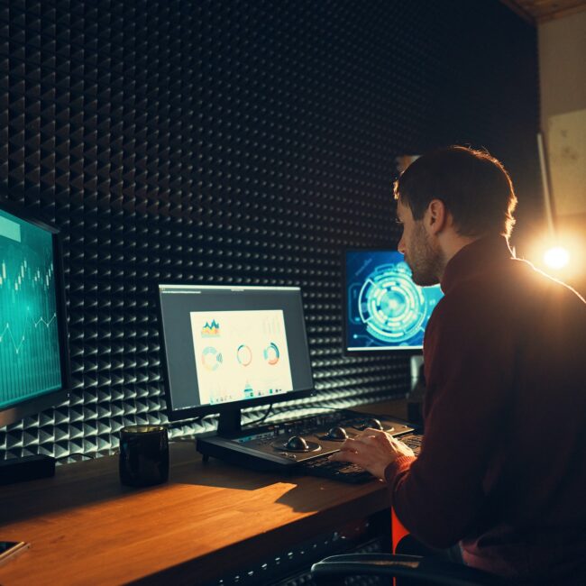 Male Videographer Edits and Cuts Footage and Sound on His Personal Computer